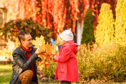 happy father and daughter on autumn natural background