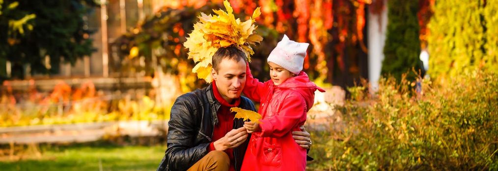 happy father and daughter on autumn natural background