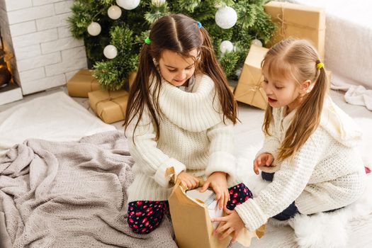 christmas, x-mas, winter, happiness concept - two adorable girls playing.