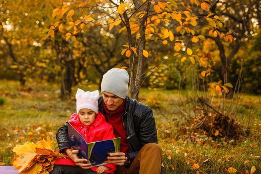 happy father and daughter on autumn natural background