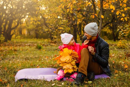 happy father and daughter on autumn natural background