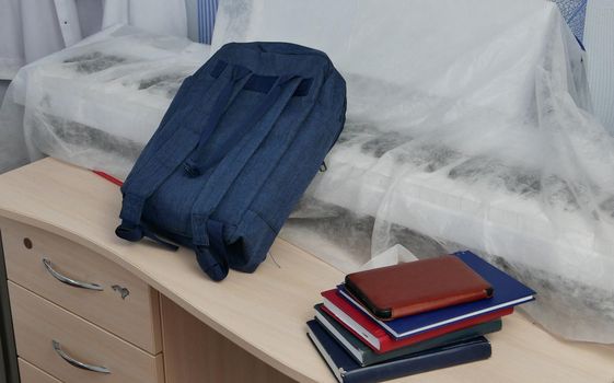 Backpack, textbooks, notebooks, electric piano on the table. getting ready for school Back to school. Back to school concept with school books, textbooks, backpack and supplies. High quality photo