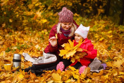 Mother daughter time. Soft focus shot of a mother and daughter reading a book together relaxing near the autumn park