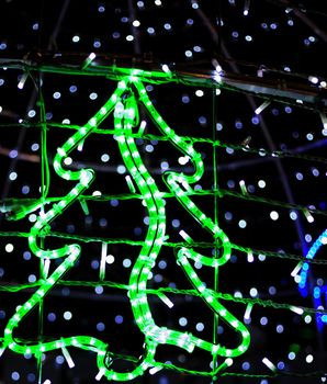 Christmas tree of green electric lights. Christmas lights, in the form of a Christmas tree,