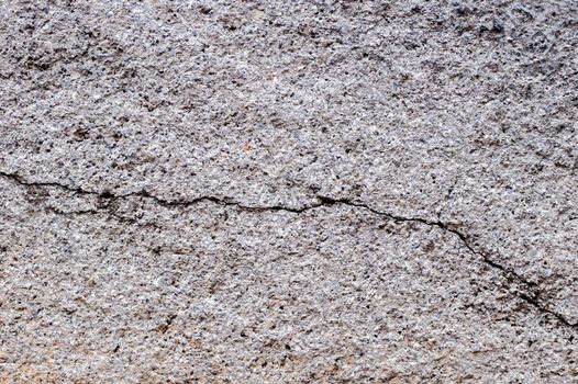 Old gray cracked stucco on the wall.