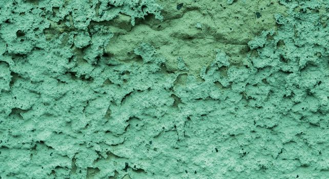 Old peeling paint on the wall..Green abstract background..Beautiful green textured stucco on the wall..Background from green stucco.