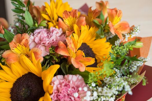 Hello August. Beautiful autumn bouquet with sunflowers and heart card close up on abstract light grey background.