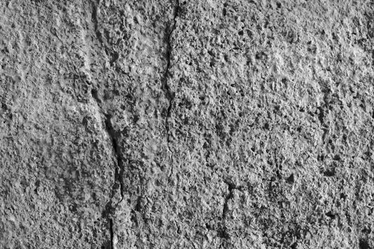 Old gray cracked stucco on the wall.