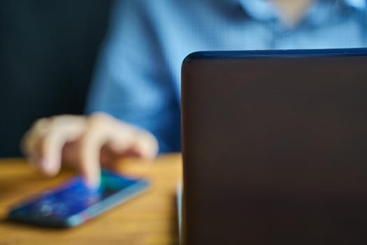 Smartphone on the table. Man using telephone.