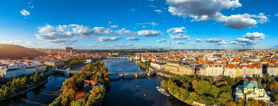 Scenic summer aerial panorama of the Old Town architecture in Prague, Czech Republic. Red roof tiles panorama of Prague old town.  Prague Old Town Square houses with traditional red roofs. Czechia.