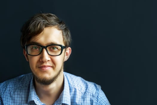 Man in glasses. Confident boy in eyeglasses looking at camera and smiling.