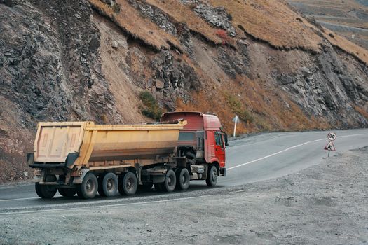 Car in the mountains. Cargo truck on the mountain highway.