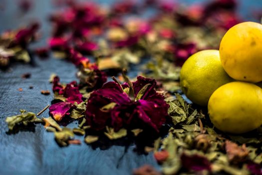 Neem or Indian Lilac face mask on the black wooden surface for oily skin consisting of neem leaves paste and lemon juice well mixed with rose water.