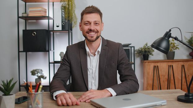 Businessman in suit closing laptop pc computer after finishing work at home office desk. Smiling male manager freelancer man busy working online, remote job. E-learning, browsing internet on notebook