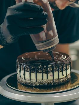 decorating a frosted cake with chocolate and nutella