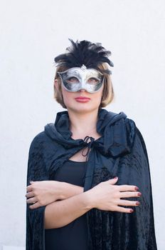 Mysterious Girl in a black cloak and a masquerade mask, mardi gras steampunk mask, a fairy tale, an enchanting story, High quality photo
