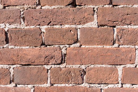 texture background brick wall made of old red brick. Close-up of old brickwork