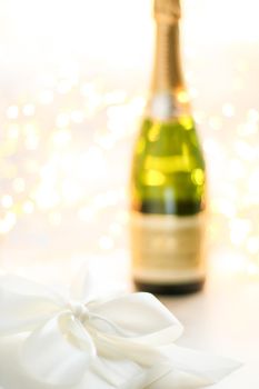 Romantic celebration, lifestyle and luxury present concept - The bottle of champagne and holiday gift box