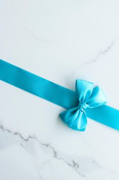 Holiday decor, feminine design and flatlay concept - Blue silk ribbon on marble, top view