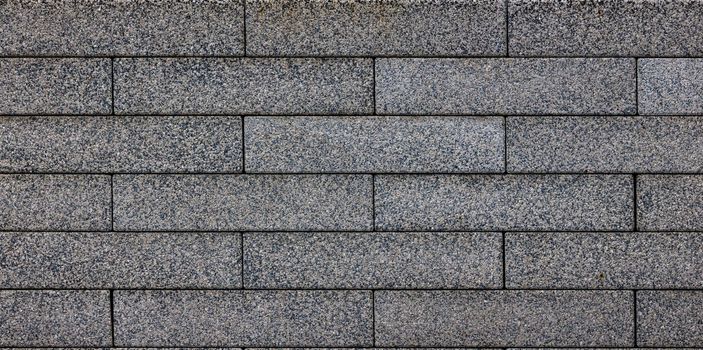 flat texture and full-frame background of gray long rectangular brick pavement.