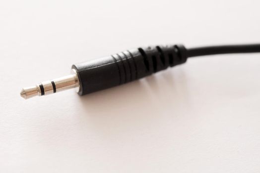 Audio jack plug stereo connector with black plastic body close-up on white background