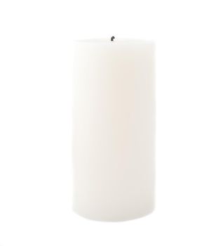 a large pillar candle isolated on a white backdrop