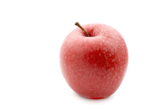 Single healthy juicy fresh red apple with a stalk over a white background
