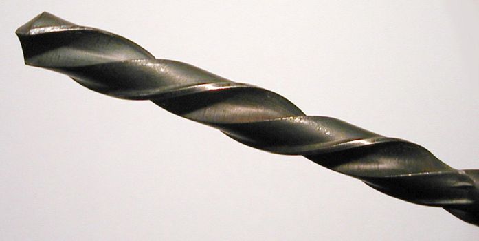 Close Up Detail of Metal Drill Bit Angled Across White Background in Panoramic Format