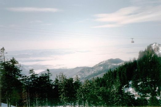 a cable car crossing a winter mountain landscape