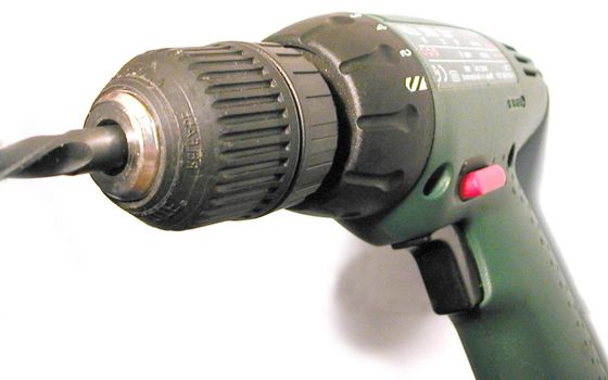 Close Up Detail of Electric Drill with Bit on White Background