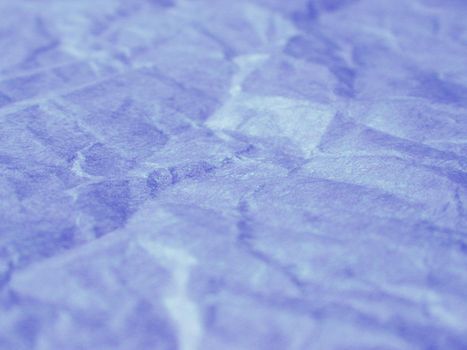 Extreme close up of wrinkled periwinkle paper creating an abstract background