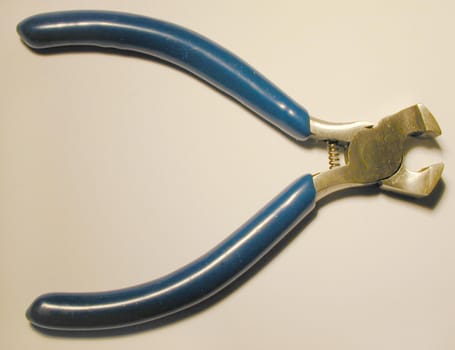 Pair of steel cutters lying open on a white background viewed from above with copy space