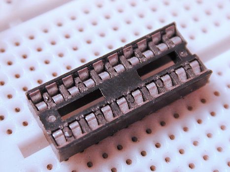 Closeup of old microchip in plastic electronic circuit board