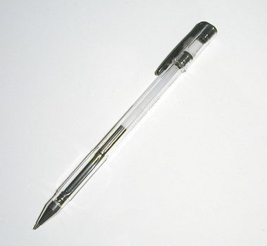 Black ball point pen or roller ball lying diagonally on white with copy space