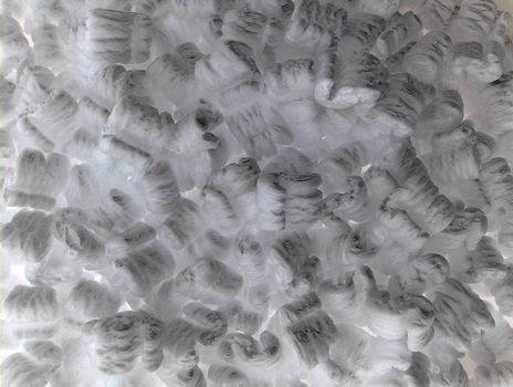 Full frame background of negative color styrofoam packing peanuts with copy space