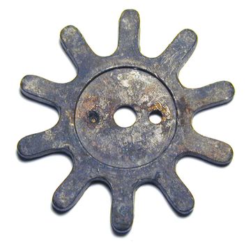 Small old vintage gearwheel, viewed in close-up and isolated on white background