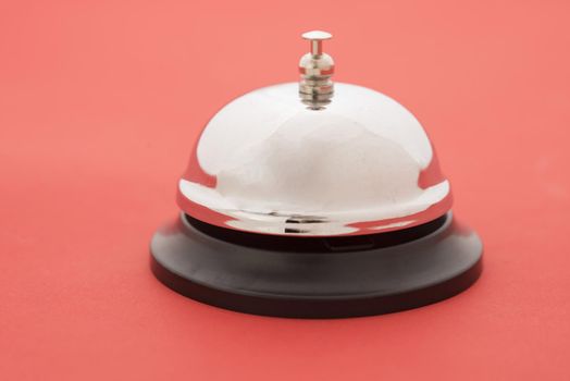 Close-up of reception bell standing against red background