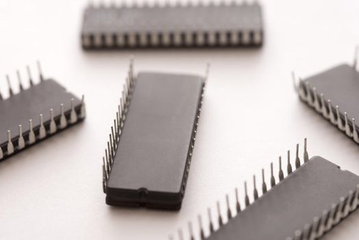 Black electronic chips upside down close-up on white surface background