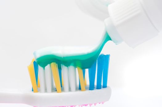 dispensing toothpaste onto a tooth brush