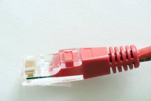 Close-up view of patchcord cable plug against white background