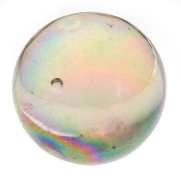 Iridescent clear glass marble with a bubble refracting the light to show a colorful spectrum isolated on white