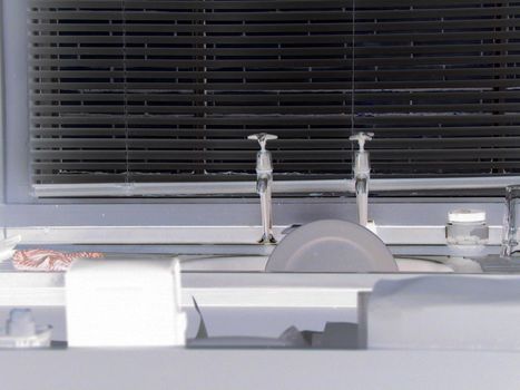 View acrosss kitchen countertops to a kitchen sink with dishes in it