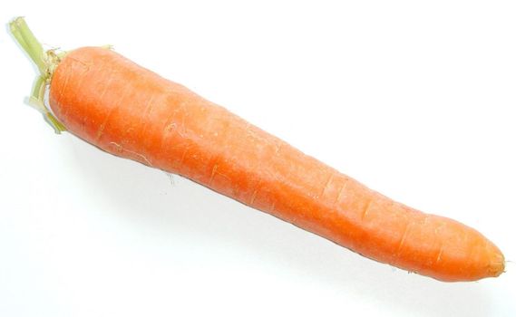 Single fresh raw whole carrot lying diagonally across the frame on a white background with copyspace