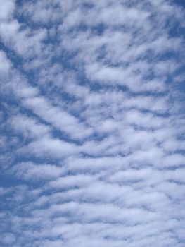 a bright fluffy clouded blue sky