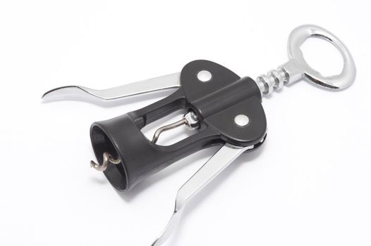 Wine bottle opener with lever mechanism and steel corkscrew lying diagonally on a white background