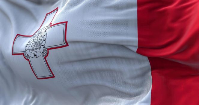 Close-up view of the Maltese national flag waving in the wind. The Republic of Malta is an island country in the Mediterranean Sea. Fabric textured background. Selective focus