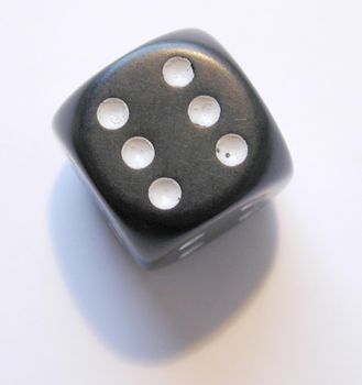 a black dice showing the number 6