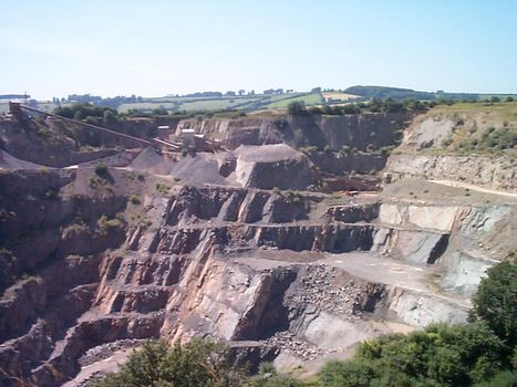 Landscape view of stepped terraces in an open cast rural quarry mining natural resources and rock