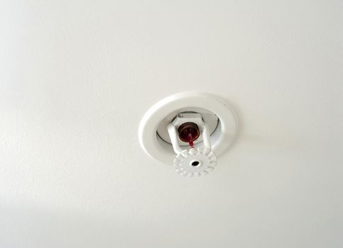 Ceiling mounted fire sprinkler which detects the increased heat from a fire and automatically sprays jets of water on the surroundings