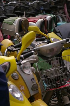 a row of scooters or mopeds parked on a street